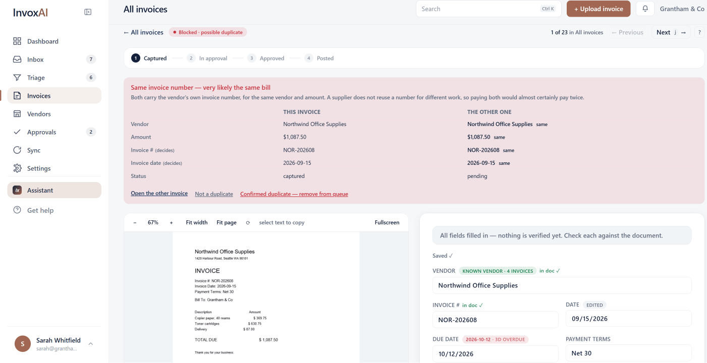 InvoxAI holding an invoice back as a possible duplicate, with this invoice and the other one side by side — same vendor, same $1,087.50, same invoice number, same date — above the choice to open the other, dismiss it, or confirm the duplicate.